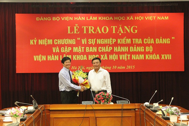 Đ/c Nguyễn Xuân Thắng trao Kỷ niệm chương và tặng hoa<br> cho đ/c Nguyễn Hữu Minh